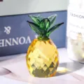 Detailed view of a yellow faceted crystal pineapple figurine with green glass leaves - Pineapple Ornament / Yellow With Green