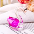 Close-up of elegant pink faceted crystal swan figurine for wedding and home decor gift - Rose Red
