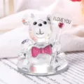 Detail shot of crystal teddy bear figurine holding an I LOVE YOU heart ornament - Pink Tie I LOVE YOU With Base