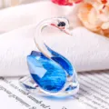 Close-up detail of blue and clear crystal swan ornament with multi-faceted cut - Blue