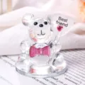 Macro view of a crystal teddy bear figurine holding a Best friend heart balloon - Pink Tie Friend With Base