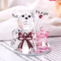 Close-up of a crystal bear figurine featuring an It's a girl heart balloon and pink milk bottle - Pink Baby Bottle Bear