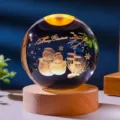 Close-up of laser-engraved snowmen inside a crystal ball night light with a wooden base - Snowman / 6cm Sphere (No Light Base)