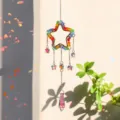 Macro view of a colorful rainbow star crystal suncatcher casting vibrant prism light - Pentagram