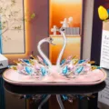 Elegant pair of colorful crystal swan figurines on a decorative pink tray for home decor - Swan Crystal Ornament Style 2 With Pink Tray / Multicolor
