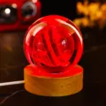 Detailed macro view of 3D engraved crystal ball night light with vibrant red glow - Mars (JYSJ-SJQ-019) / Color 60 Ball With Wood Warm Light Base