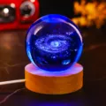 Close-up of glowing 3D laser-engraved galaxy crystal ball night light on wooden base. - Galaxy (JYSJ-SJQ-019) / Color 60 Ball With Wood Warm Light Base