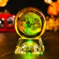 Close-up of 3D laser engraved crystal ball with earth pattern on glowing base - Moon (JYSJ-SJQ-019) / Color 60 Ball With Rechargeable Color Light Crystal Base