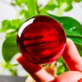 Close-up of a hand-held glowing red crystal ball ornament with a translucent glossy finish - Mars (JYSJ-SJQ-019) / 60 Single Sphere