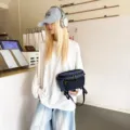 Κοντινό πλάνο μπλε καρό λειτουργικής τσάντας μέσης σε ένα μοντέρνο σκηνικό καφέ techwear - Μαύρο