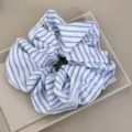 Detail view of a blue and white striped oversized fabric scrunchie in a gift tray - Blue White Scrunchie - Thick Stripe