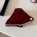 Close-up of retro red velvet headband with pearl trim and bow charm detail - Red Pearl Hair Claw