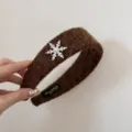 Close-up detail of a brown fuzzy winter headband featuring a rhinestone snowflake charm - Coffee - Snowflake Headband