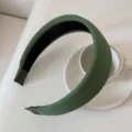 Detail view of a stylish wide green padded headband with soft ribbed fabric finish. - 5cm Wide / Green
