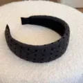 Vue rapprochée d'un serre-tête en velours gris à pois noirs et texture douce. - Petits Pois / Largeur 4cm / Gris