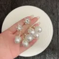 Close-up detail of French Baroque style floral earrings with white pearls and crystals - Petal Artificial Pearl Tassel Style (E4885) / Gold