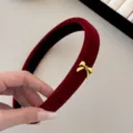 Elegant red velvet padded headband with a tiny gold bow detail, chic festive hair accessory. - Headband / Red