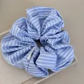 Close-up detail showing the texture and blue striped pattern of this stylish hair scrunchie. - Blue White Scrunchie - Double Stripe