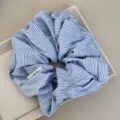 Close-up detail of a blue and white striped oversized fabric scrunchie in a tray - Blue White Scrunchie - Thin Stripe