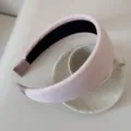 Detailed macro view of a light pink ribbed padded headband on a ceramic teacup. - 5cm Wide / Light Pink