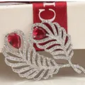 Elegant vintage feather brooch with red teardrop zircons and micro-pave crystals - Ruby Red