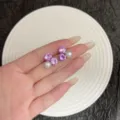 Detailed close-up view of elegant stud earrings featuring purple rhinestones and pearls - Exquisite Three-Star (E4934) / Silver Purple