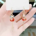 Detail of Chinese style lucky bag tassel earrings with red stones and gold finish - Fortune Bag Tassel Style (E1181) / Gold Red