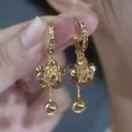 Macro view of vintage gold floral drop earrings with sparkling amber crystals. - Five-Petal Flower Tassel Style (E4233) / Champagne