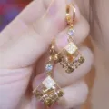 Close-up of sparkling coffee brown crystal earrings in a vintage gold-tone frame. - Double Layer Rhombus Geometric Style (E4388) / Champagne