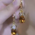 Elegant vintage gold-tone amber teardrop earrings with sparkling crystal leaf detail - Marquise Rhinestone Leaf Tassel Style (E4395) / Champagne