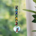 Detailed view of a rainbow maker suncatcher with colorful heart crystals and prism - Heart Pendant