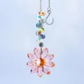 Detail view of crystal sunflower suncatcher with pink petals and faceted beads. - Pink