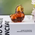 Nahaufnahme einer bernsteinfarbenen Pferdefigur aus Glas mit glänzender Textur - Orange