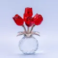 Close-up detail shot of red crystal rose flowers with shiny silver stems and a clear faceted vase. - Bright Red