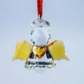 Detailed view of a faceted crystal angel suncatcher with a yellow heart and golden wings - Angel with Heart / Yellow Wings