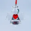 Detailed close-up of a faceted crystal angel suncatcher with a vibrant red heart - Angel with Heart / White Wings