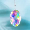 Macro view of a faceted oval AB crystal prism pendant showing rainbow light refraction. - AB Aurora Iridescent / With Lanyard