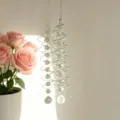Detailed view of sun catcher showing prism reflections on wall. - Green