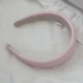 Detail view of a light pink padded leather headband with high-top sponge design. - Pink