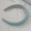 Detailed view of the light blue glossy leather sponge headband with padded design - Green
