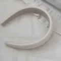 Macro view of minimalist cream faux leather padded headband with soft sponge texture - Beige