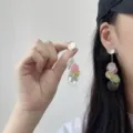 Close-up view of colorful resin tassel earrings shown worn on ear for size reference - Dopamine Colorful Tassel Style (E4901) / Gold