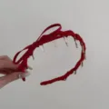Elegant red pleated satin headband featuring a delicate ribbon bow and clear teeth. - Bow Wavy Headband / Red