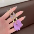Detail of elegant purple petal tassel earrings with cat's eye stone and gold hook - Floral Style (E1557) / Gold/Purple