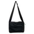 Minimalist black canvas crossbody bag featuring a wide shoulder strap and front zipper pocket - No Pendant / Black