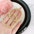 Fashionable large textured gold geometric hoop earrings with a faceted segmented design - Geometric Faceted Hoop (E0270) / 5cm / Gold