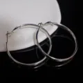 Classic large silver-colored hoop earrings with a sleek polished metallic finish. - Polished Hoop Style (E3782) / 4cm / Silver