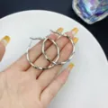 Large silver-colored twisted hoop earrings with a textured geometric design for women - Twisted Texture Hoop Style (E2171) / 4cm / Silver