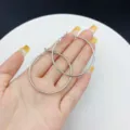 Large trendy silver hoop earrings with a textured geometric design held in hand for scale - Geometric Textured Hoop Style (E2553) / 4.50cm / Silver