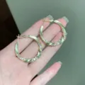 Elegant gold twisted hoop earrings with sparkling rhinestones in a geometric style. - Spiral Texture Rhinestone Style (E3834) / 3.3cm / Gold